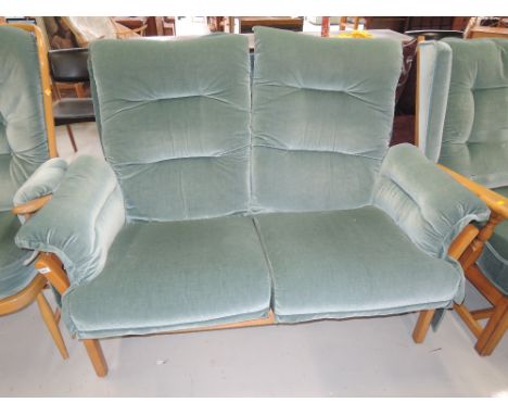 A double seat couch by Ercol in a light beech finish