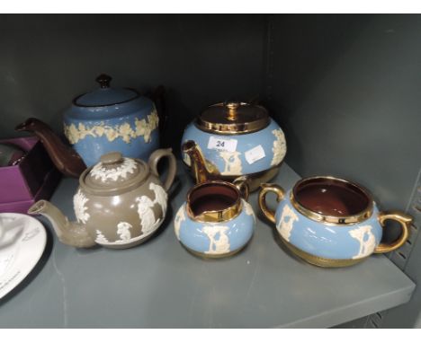 A selection of vintage tea pots and cream jug in a Wedgewood Jasper ware design including Gibsons