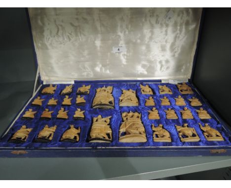 A vintage carved wood chess set in case with Indian theme figures
