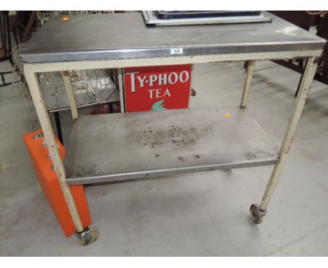 A genuine vintage medical trolly with heavy cast frame and stainless steel top and shelf