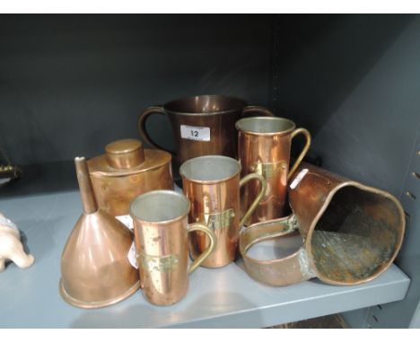 A selection of vintage copper measures and loving cup marked George and Dragon