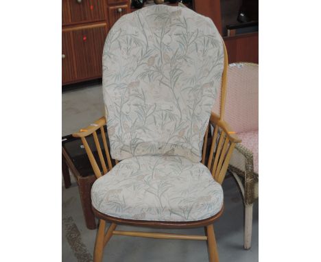 A vintage Ercol armchair in a light beech with yew seat 