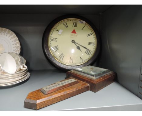 A vintage wall mounted clock and barometer