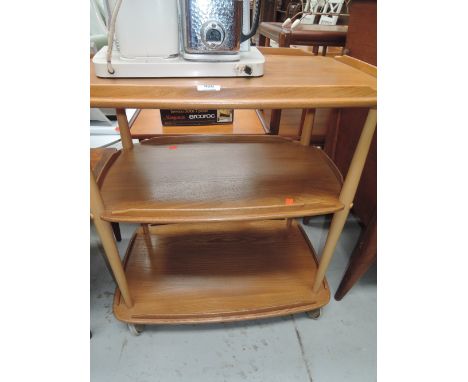 A vintage Ercol tea trolly in a light oak and beech wood