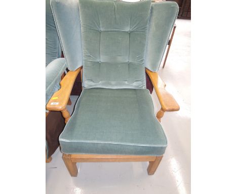 An easy style wing back arm chair in a light beech finish by Ercol