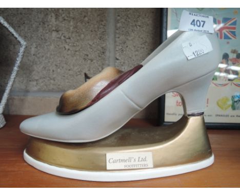 A vintage ceramic advertisement for Cartmell shoe fitters cat in stiletto 
