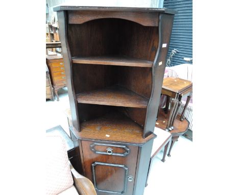 An oak effect corner shelf with cabinet under