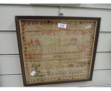 A vintage needlework with alphabet and religious quotes