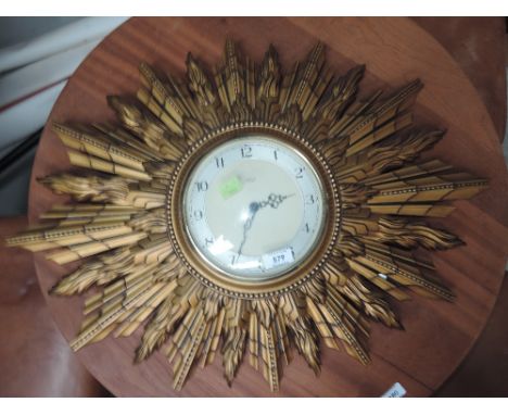 A vintage wall clock by Smiths with star burst designPlastic