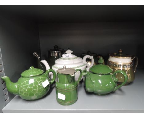 A selection of vintage teapots in a green palette