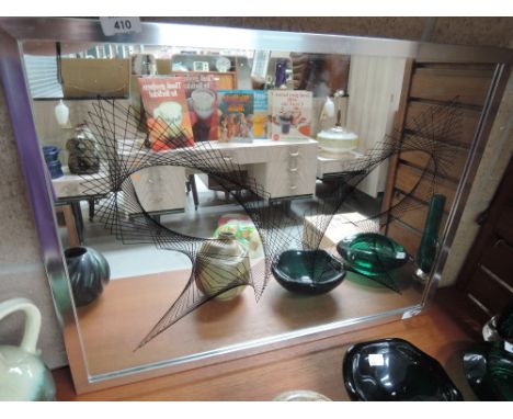 A vintage geometric wall mirror in an 80's design