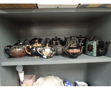 A selection of vintage teapots in a black and gold trim hand decorated etc