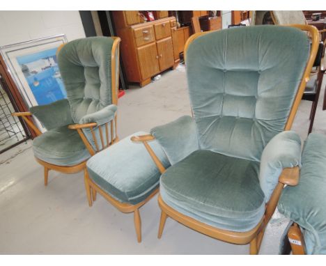 A pair of wing back arm chairs and foot stool by Ercol in a light beech finish
