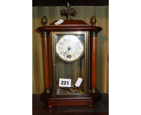 Mantle clock with painted porcelain dial, four glass case flanked by turned wood pillars with brass mounts, and the movement 