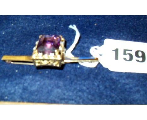 14ct (.585) gold brooch set with large lozenge cut amethyst flanked by eight small diamonds (15gms approx)
