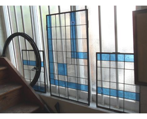 Three Art Deco panels of stained glass in brass frames
