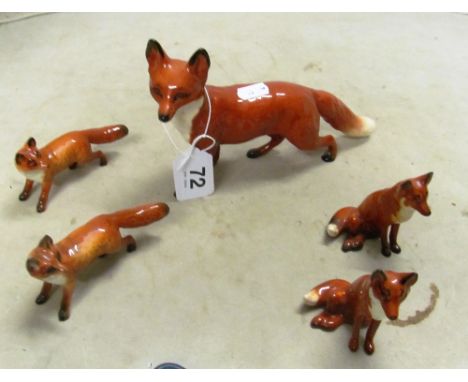 A large Beswick fox and four smaller Beswick foxes