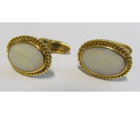 A pair opal cufflinks marked 750, 12.5g