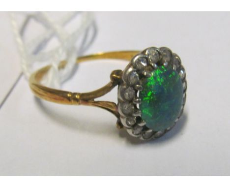 An 18ct gold opal and diamond ringwould say stone pin hole pitted/rough7x6mm approx