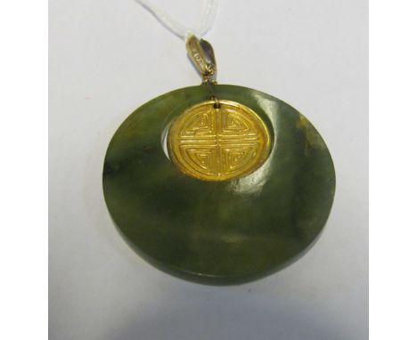 A circular jade pendant with gilt circle of a bird