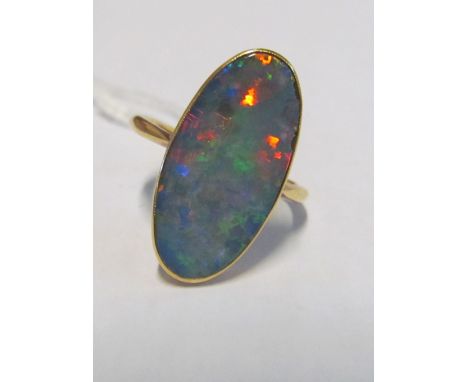 An oval opal ring marked 18k2 chips to edge, scuff mark and minor scratches 19mm x 10mm apprx