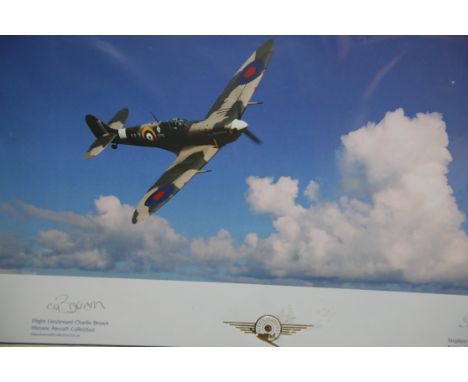 Contemporary mounted photographic print of a Spitfire in flight by Action Stations!, signed to the border by Flight Lieut Cha