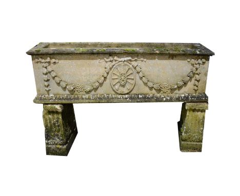 Haddonstone Adam trough, length 122cm, on two scrolled supports, overall height 75cm.