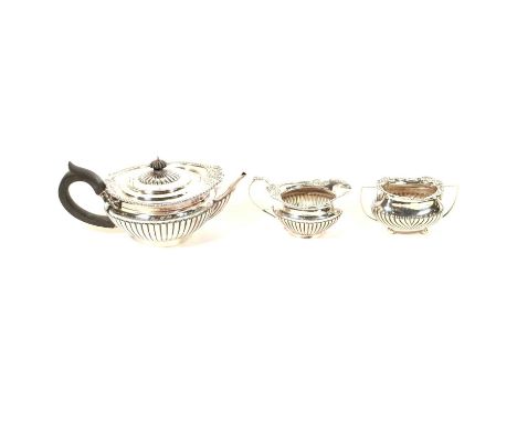 Silver matched three piece tea set, comprising teapot and milk jug by Walter &amp; John Barnard, London 1893, cast edge and h