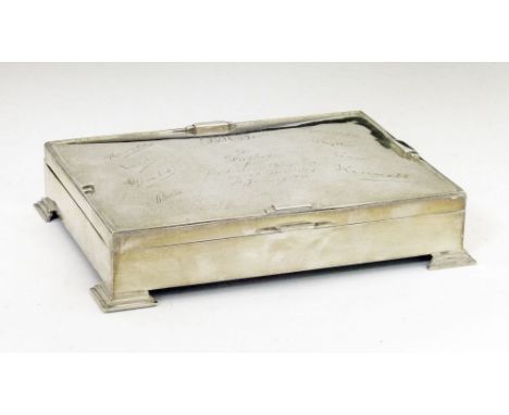 George V silver rectangular box, the hinged cover with presentation inscription and signatures and standing on stepped bracke