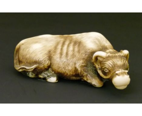 Japanese finely carved ivory netsuke, Meiji period, in the form of a recumbent ox, having inset mother-of-pearl eyes and with