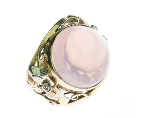 Rose quartz cabochon set 9ct gold ring between two colour ivy leaf shoulders with diamond points, finger size K, 10.5g gross,