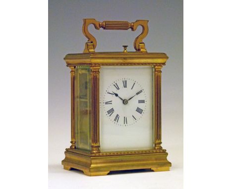 French brass cased carriage clock having a repeat movement, white enamel dial with Roman numerals flanked by Corinthian colum