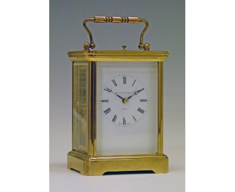 Modern Swiss brass cased carriage clock having a repeat movement, white enamel dial with Roman numerals, movement striking on
