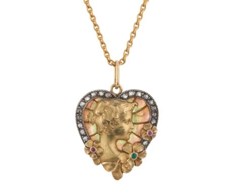 An Art Nouveau gold and silver, plique-a-jour enamel and rose-cut diamond portrait pendant, with emerald and ruby highlights,