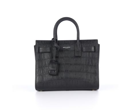 Saint Laurent, a nano Sac De Jour handbag, featuring a black crocodile embossed leather exterior, with accordion sides, loopi