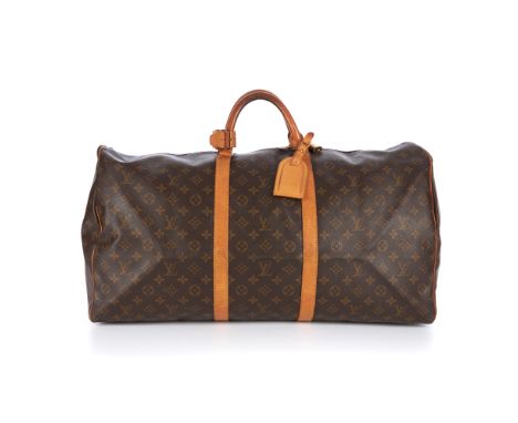 Louis Vuitton, a monogram Keepall 60 luggage bag, featuring the maker's classic monogram coated canvas exterior and natural l