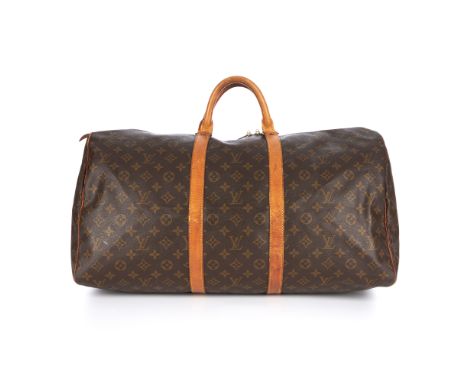 Louis Vuitton, a monogram Keepall 55 luggage bag, featuring the maker's classic monogram coated canvas exterior and tan leath