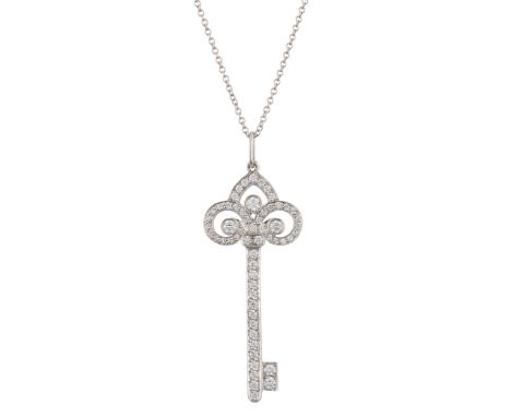 Tiffany & Co., a platinum pave-set diamond Fleur de Lis Key pendant, suspended from a platinum trace-link chain, signed Tiffa