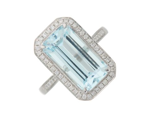 An 18ct gold aquamarine and brilliant-cut diamond cluster ring, with similarly-cut diamond line shoulders, aquamarine weight 