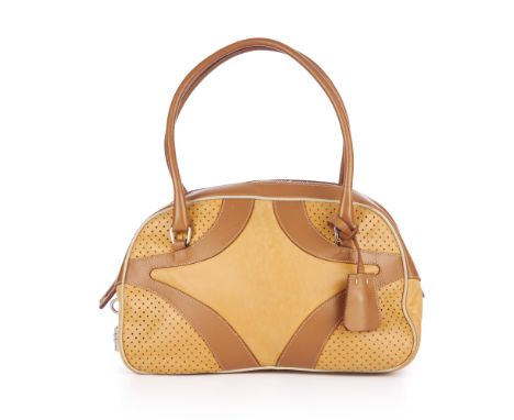 Prada, a Bowling bag, designed with a smooth tan and caramel leather exterior, with perforated detailing, silver-tone hardwar