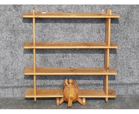 A pine novelty wall shelf in the form of a plane.