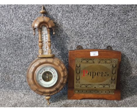 An oak and brass wall mounted papers rack and a barometer (SAS).