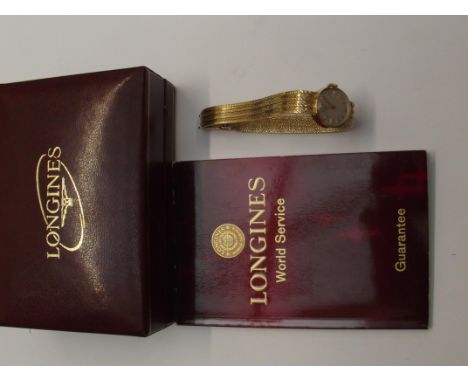 9ct gold Longines lady's manual wind wristwatch. 9ct gold strap and case with champagne dial. Ticking and keeping good time o