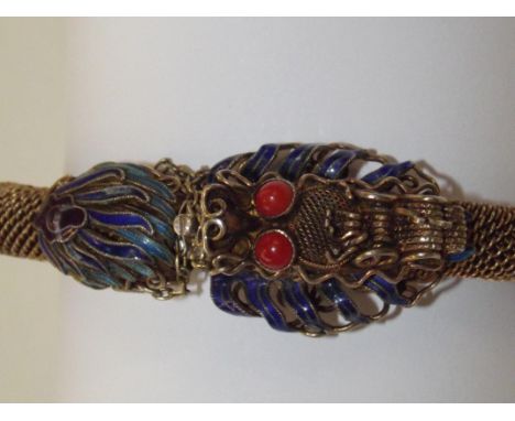 Silver Chinese bangle, gilded with enamel with dragons head, possibly coral eyes