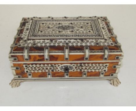 19th century Vizagapatam trinket casket, bone lattice work and strapwork on tortoiseshell, velvet lined and carried on paw fe