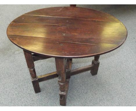 18th century oak coaching table, folding oval top 73cm x 49cm on a folding turned gate base, height 57cm