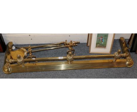 A brass fire curb; a pair of andirons; and a pair of matching fire tools 