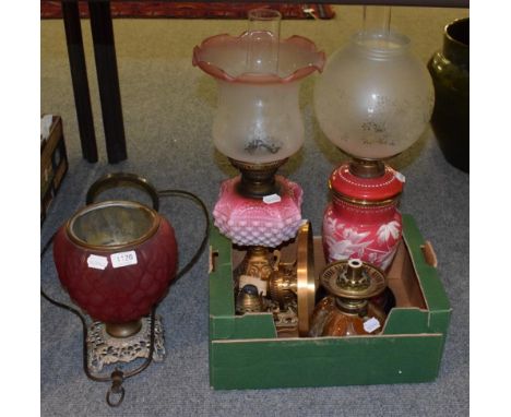 Two Victorian oil lamps; a Victorian ruby glass oil lamp base; a Linthorpe pottery oil lamp reservoir etc