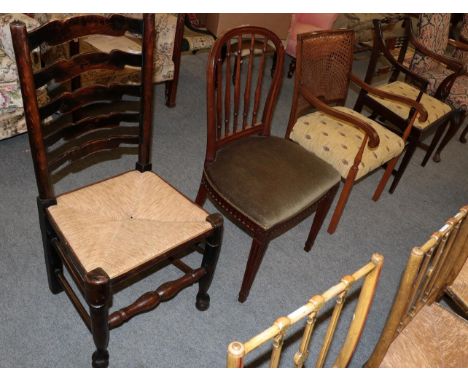 A Regency style mahogany armchair; an early 20th century cane back armchair; a mahogany spindle back dining chair; and a rush