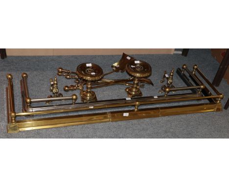 Two brass trivets; a fender; andirons; a curb; and tools 